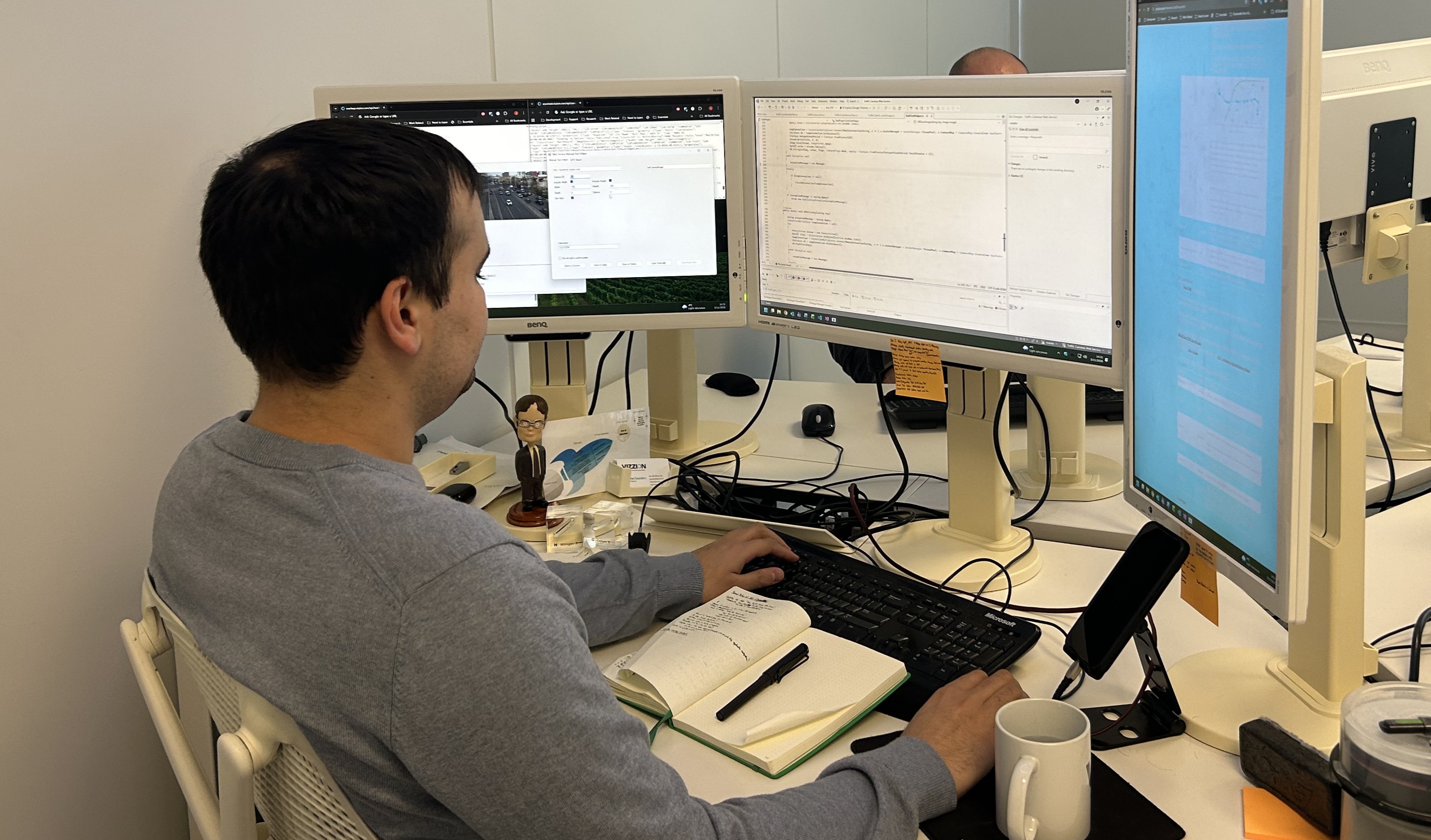 Software Engineers discussing system design at the Vizzion office.